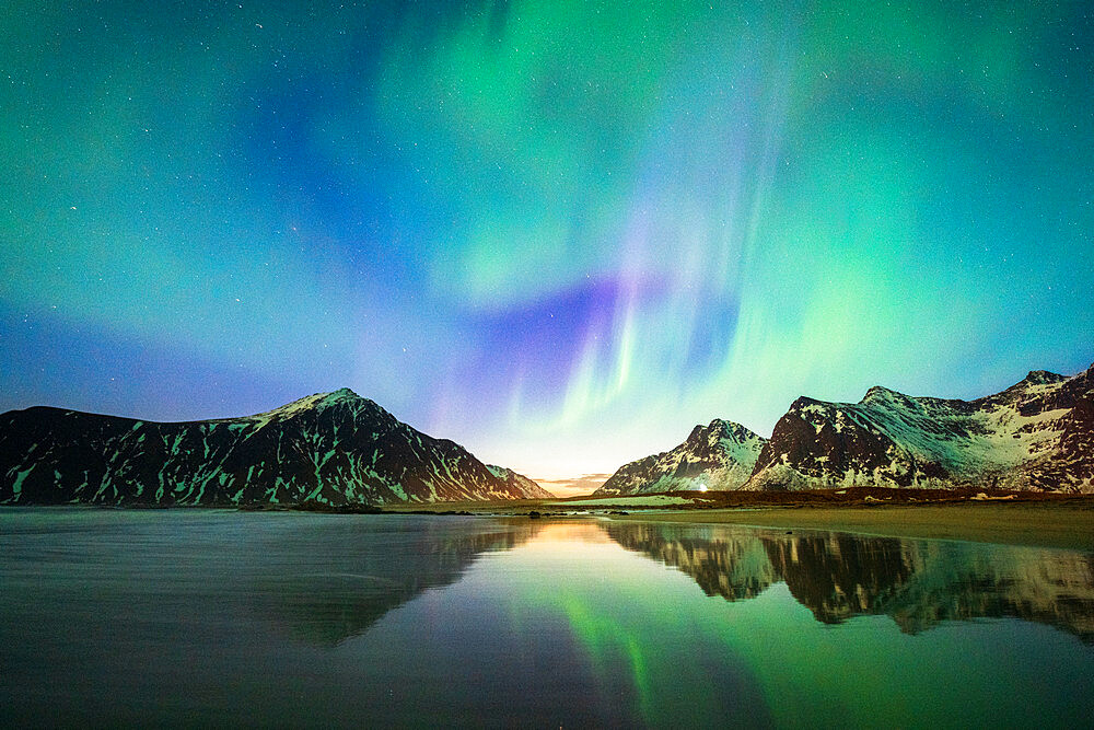 Bright night sky with Aurora Borealis (Northern Lights) over mountains and Skagsanden beach, Flakstad, Lofoten Islands, Norway, Scandinavia, Europe