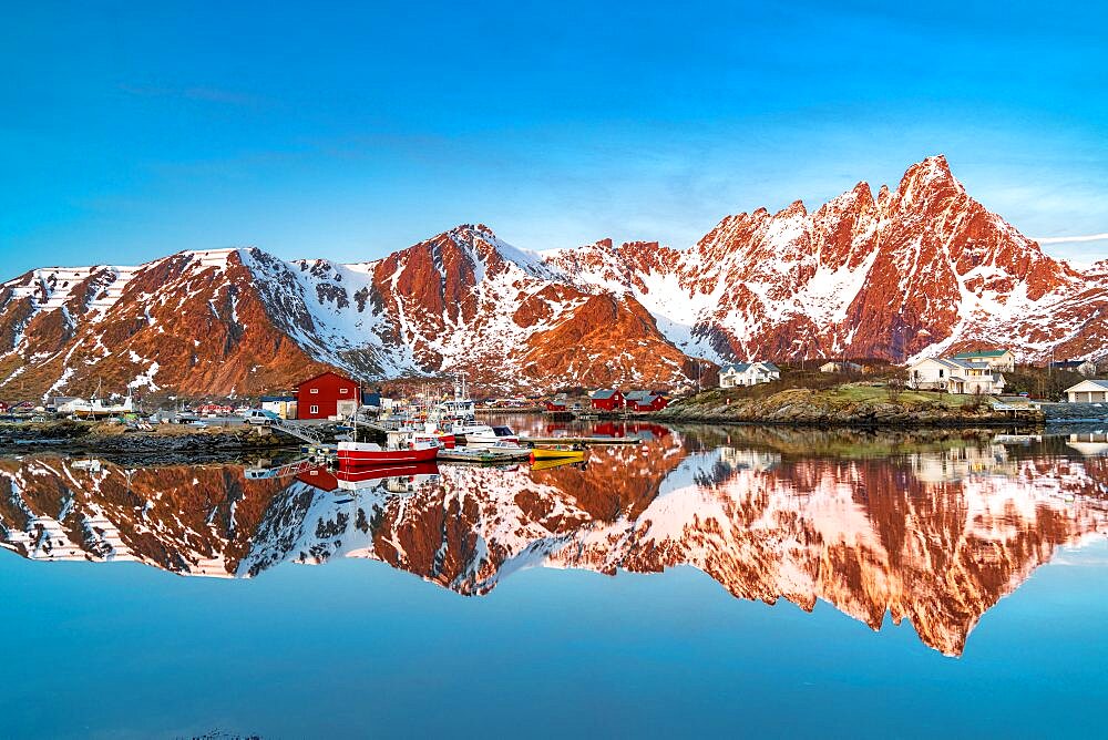 Mountains reflected in the cold sea at sunrise, Ballstad, Vestvagoy, Lofoten Islands, Norway