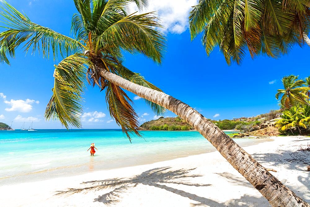 Cheerful woman sunbathing in the crystal Caribbean sea, Antigua, Leeward Islands, West Indies