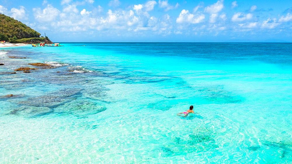 Beautiful woman enjoying swimming in the crystal Caribbean Sea, Antigua, Antigua & Barbuda, Leeward Islands, West Indies