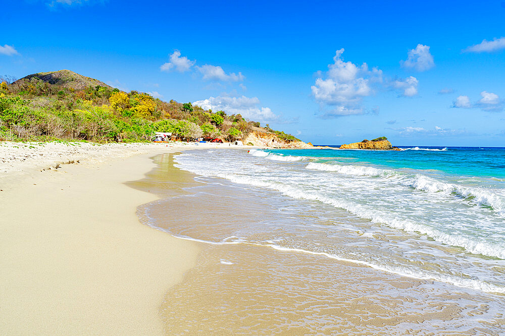 Waves of blue Caribbean Sea crashing on the idyllic tropical Rendezvous Beach, Antigua, Leeward Islands, West Indies, Caribbean, Central America