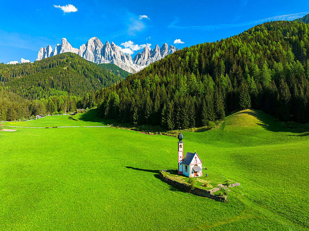 Aerial view of the Odle and iconic chapel of St. John in Ranui in spring, St. Magdalena, Funes Valley, Dolomites, South Tyrol, Italy, Europe