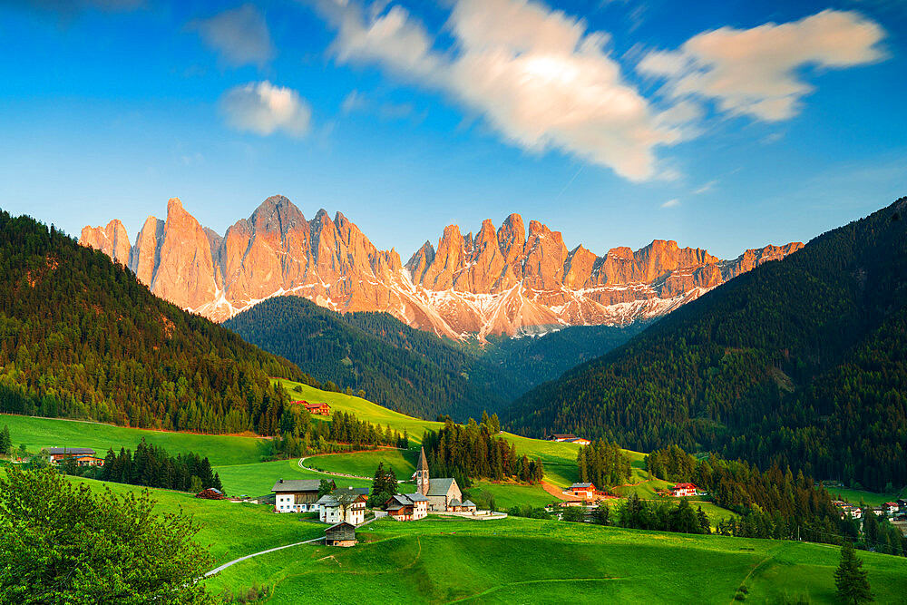 Sunset over the Odle peaks and the alpine village of Santa Magdalena in spring, Funes Valley, South Tyrol, Italy, Europe