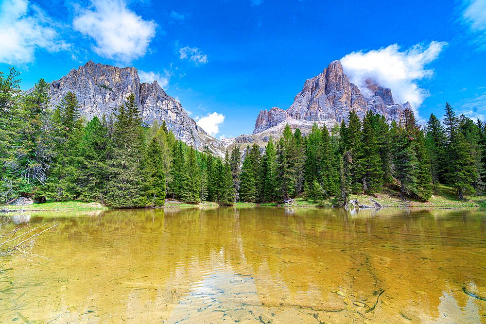 Majestic rock peak of Tofana di Rozes mirrored in the clear water of lake Bai De Dones, Dolomites, Lagazuoi Pass, Veneto, Italy, Europe