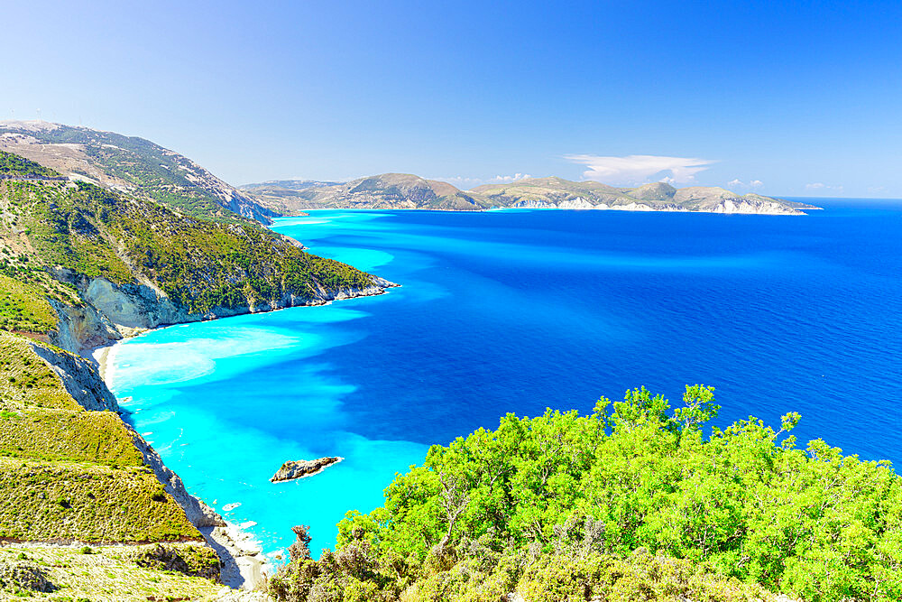 Lush plants on coastline above the turquoise lagoon surrounding Myrtos beach, Kefalonia, Ionian Islands, Greek Islands, Greece, Europe