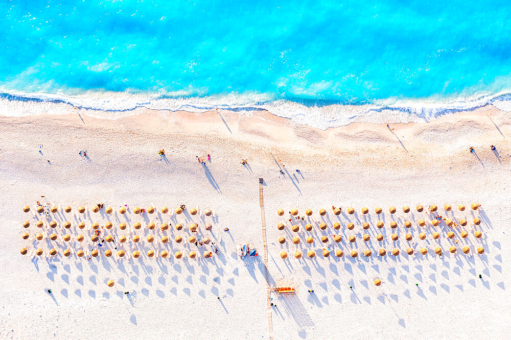 Aerial view of beach umbrellas on famous Myrtos beach at sunset, Kefalonia, Ionian Islands, Greek Islands, Greece, Europe