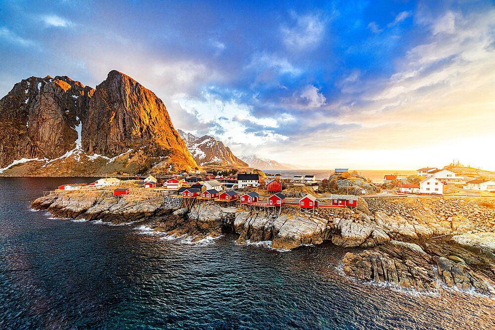 High angle view of majestic mountains and Hamnoy village lit by the warm light of sunrise, Reine, Lofoten Islands, Norway, Europe