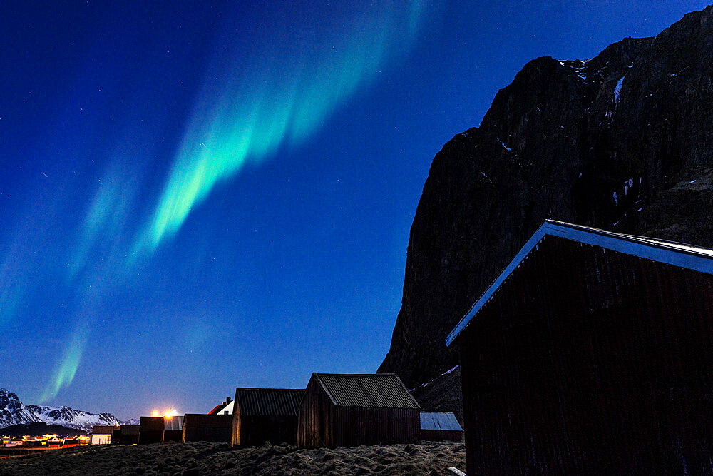 Northern Lights (Aurora Borealis) in the starry night sky over fishermen's cabins, Eggum, Vestvagoy, Nordland county, Lofoten Islands, Norway, Scandinavia, Europe