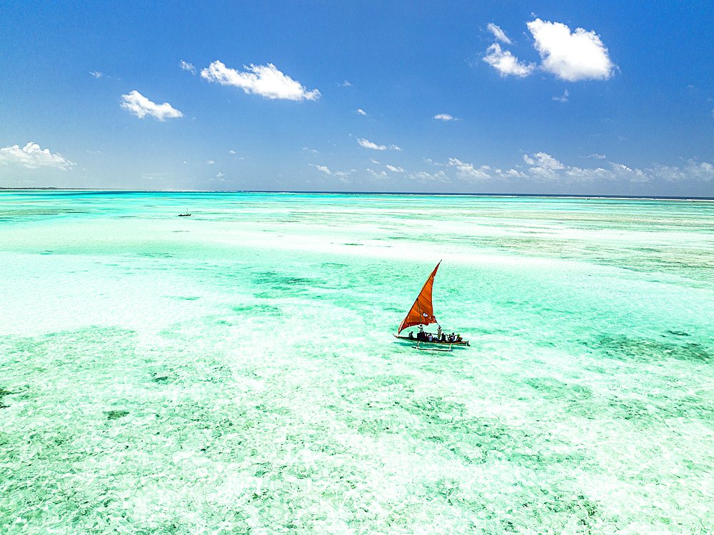 Tourists enjoying a boat trip on traditional dhow in the crystal sea, Paje, Jambiani, Zanzibar, Tanzania, East Africa, Africa