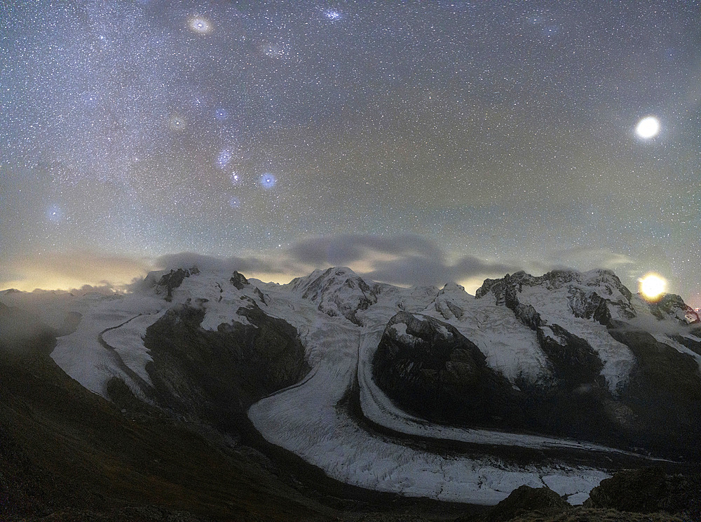 Panoramic of majestic Monte Rosa glacier under the bright stars at night, Gornergrat, Zermatt, canton of Valais, Switzerland, Europe