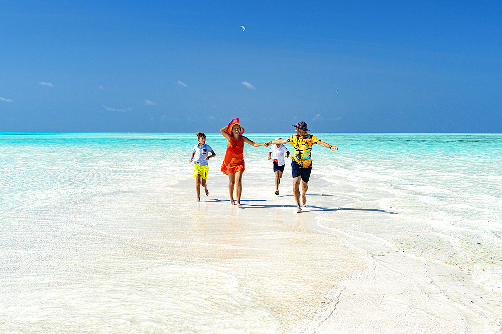 Family with two boys having fun running together on idyllic beach, Zanzibar, Tanzania, East Africa, Africa