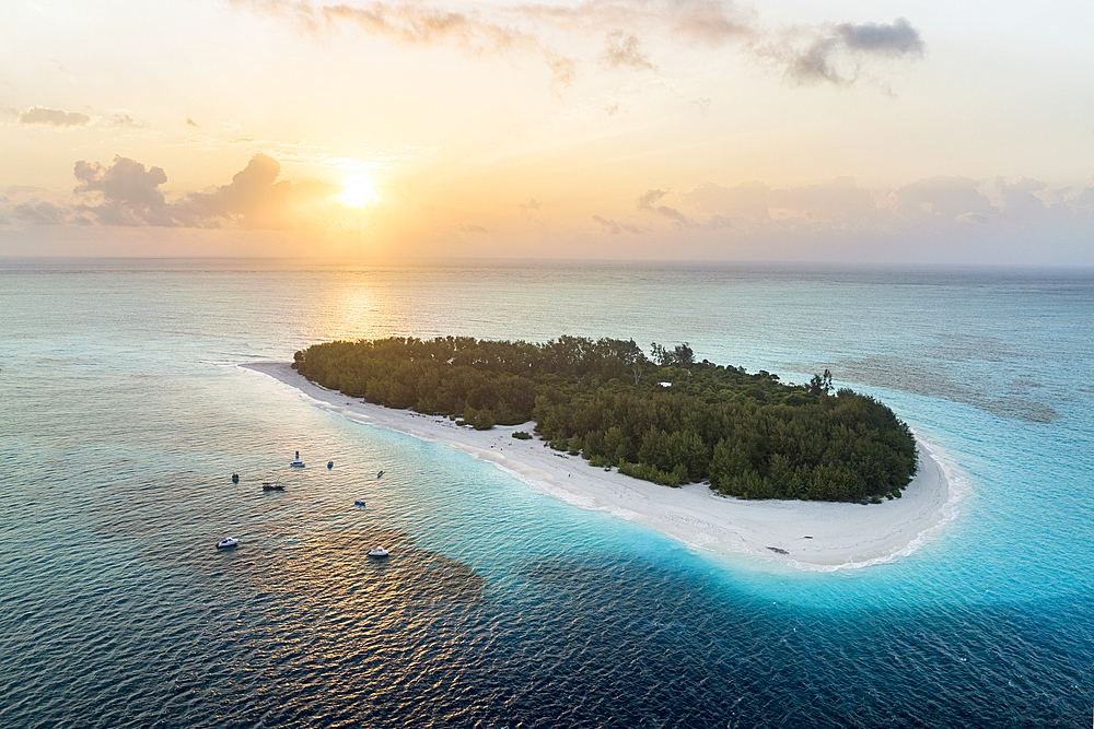 Tropical island washed by the crystal water of the exotic lagoon at sunrise, Mnemba Island, Zanzibar, Tanzania, East Africa, Africa