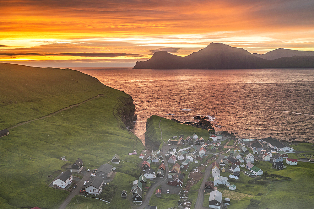 Fiery sky at dawn over Kalsoy island and the village of Gjogv, overhead view, Eysturoy Island, Faroe Islands, Denmark, Europe