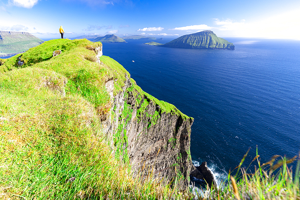 One person admiring the view standing on cliffs above the ocean, Nordradalur, Streymoy Island, Faroe Islands, Denmark, Europe