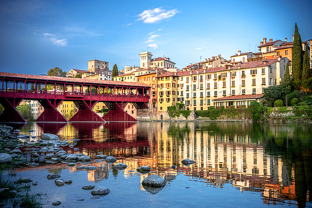 Sunset over the iconic Ponte Vecchio bridge reflected in river Brenta, Bassano Del Grappa, Vicenza province, Veneto, Italy, Europe