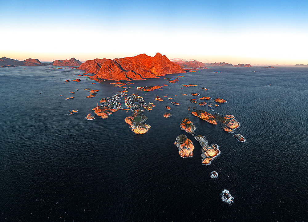 Panoramic aerial view of the fishing village of Henningsvaer and mountains at sunset, Nordland county, Lofoten Islands, Norway, Scandinavia, Europe