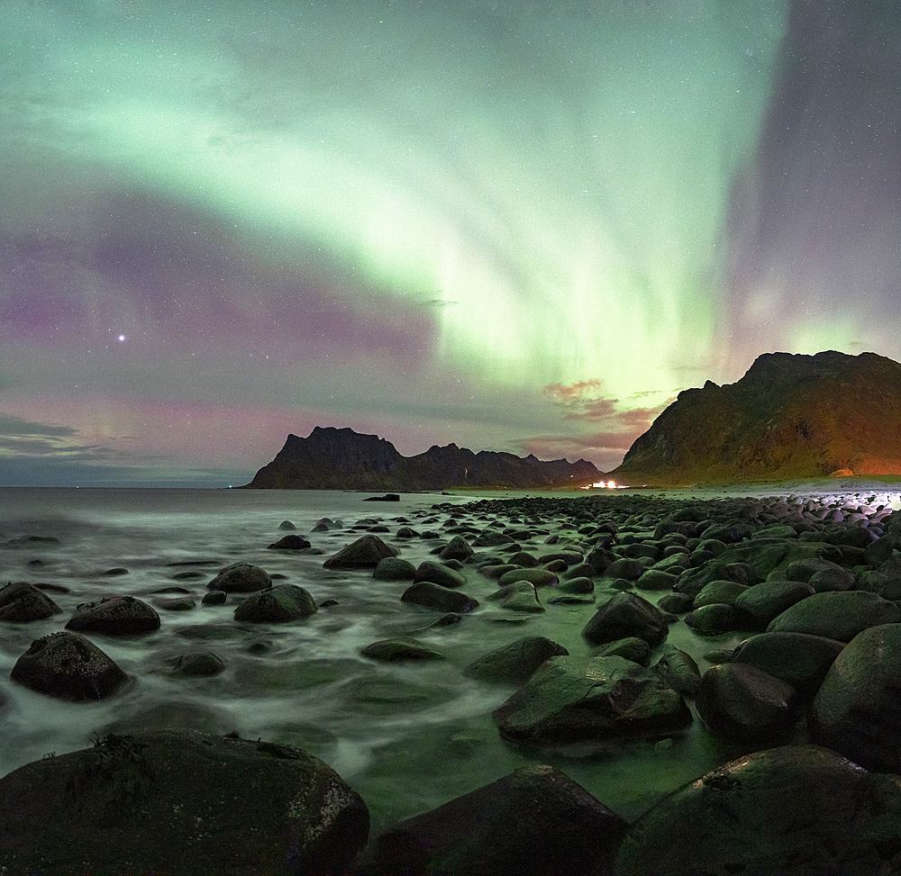 Waves crashing on rocks at Uttakleiv beach under the Aurora Borealis (Northern Lights), Vestvagoy, Lofoten Islands, Nordland, Norway, Scandinavia, Europe