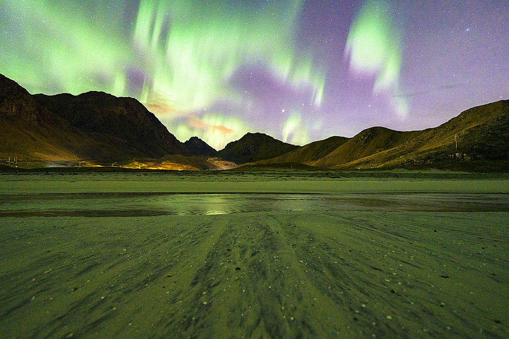 Starry sky with Aurora Borealis (Northern Lights) over the frozen Haukland beach, Lofoten Islands, Nordland, Norway, Scandinavia, Europe