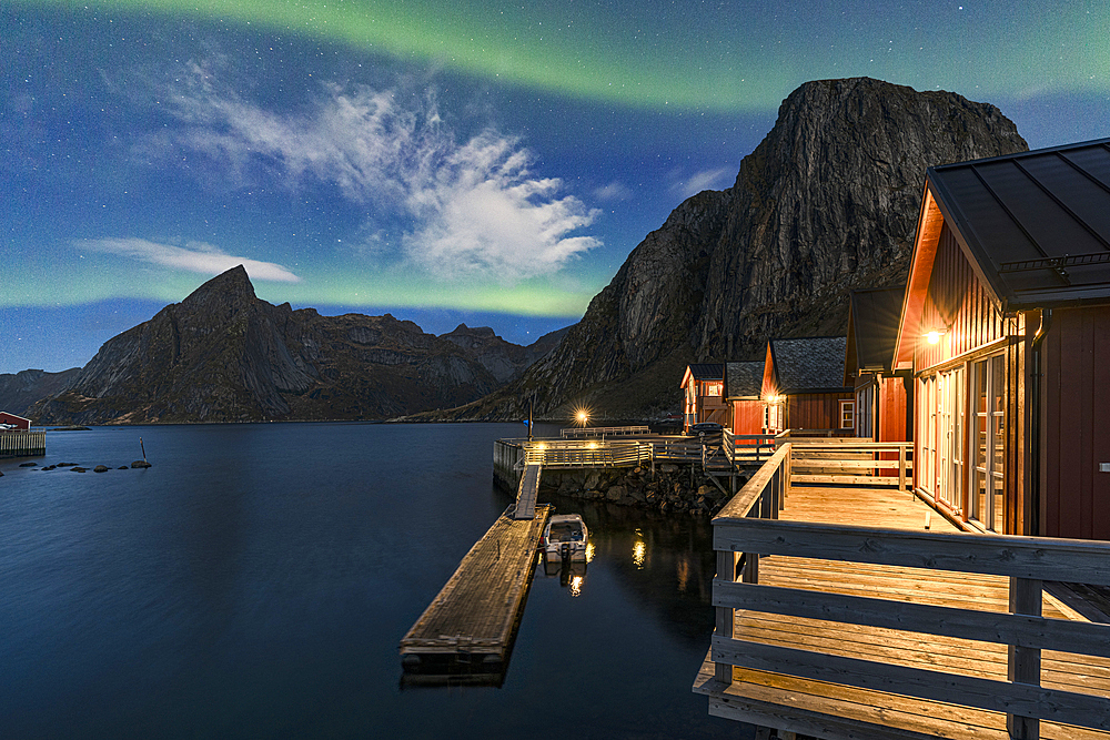 Aurora Borealis (Northern Lights) over traditional cottages along the fjord, Hamnoy, Reine, Lofoten Islands, Nordland, Norway, Scandinavia, Europe