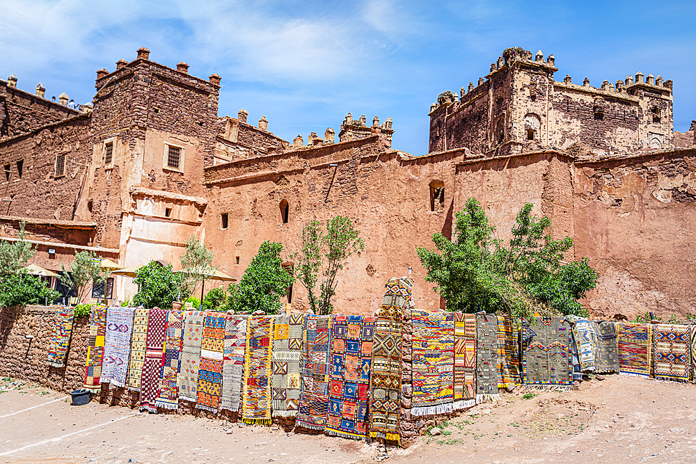 Colorful handmade carpets for sale hanging outside the old ruins of Telouet Kasbah, High Atlas mountains, Morocco, North Africa, Africa