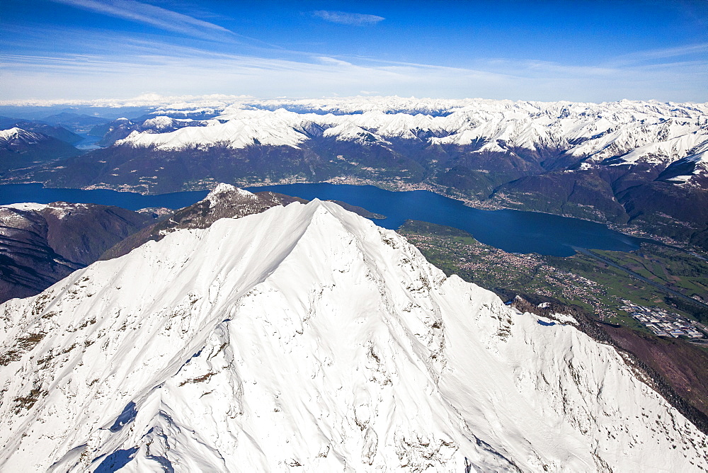 The peak of Mount Legnone coveres in snow and Lake Como and the Monti Lariani in the background, Lombardy, Italy, Europe