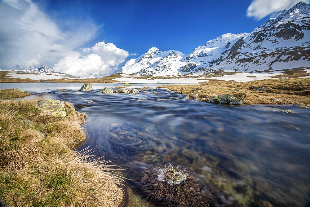 Lej Pitschen surrounded by snow capped mountains, Bernina Pass, Engadine, Canton of Graubunden, Switzerland, Europe