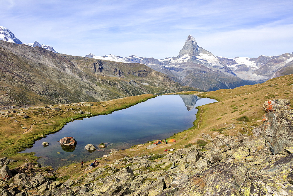 Hikers admire the Matterhorn reflected in Lake Stellisee, Zermatt, Canton of Valais, Pennine Alps, Swiss Alps, Switzerland, Europe