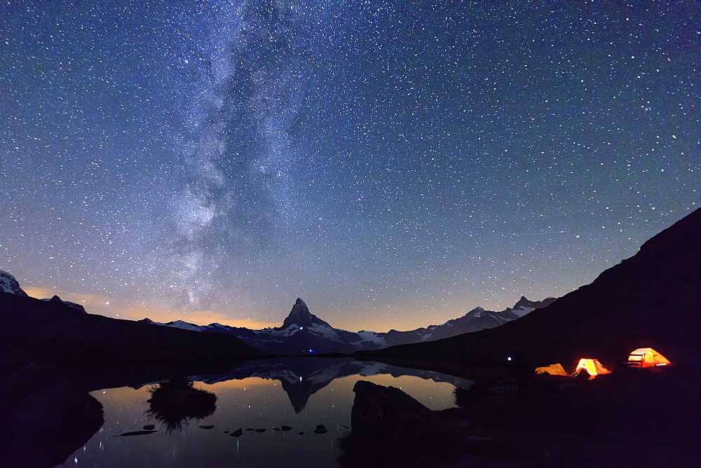 Camping under the stars and Milky Way with Matterhorn reflected in Lake Stellisee, Zermatt, Canton of Valais, Swiss Alps, Switzerland, Europe