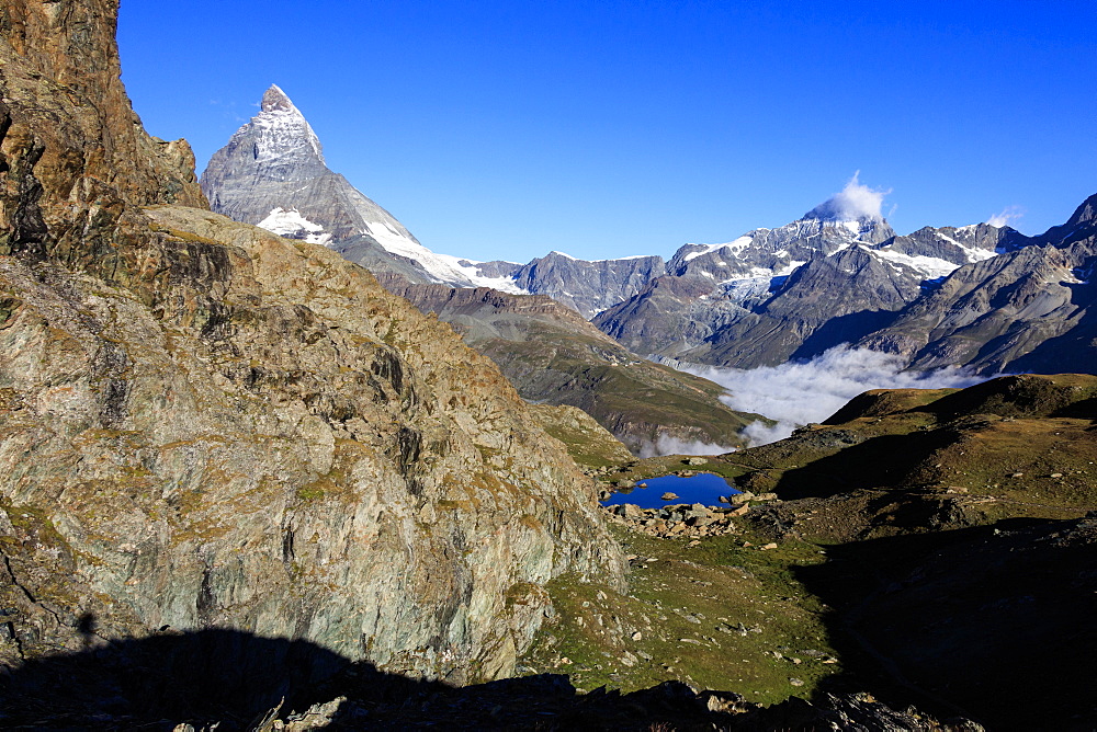 Matterhorn and Dent Blanche and the blue waters of Lake Riffelsee, Zermatt, Canton of Valais, Pennine Alps, Swiss Alps, Switzerland, Europe