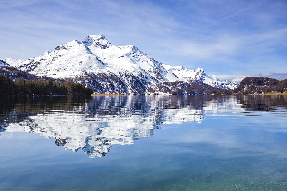 Piz da la Margna is reflected in the clear water of Lake Sils, Maloja Pass, Engadine, Canton of Graubunden, Switzerland, Europe