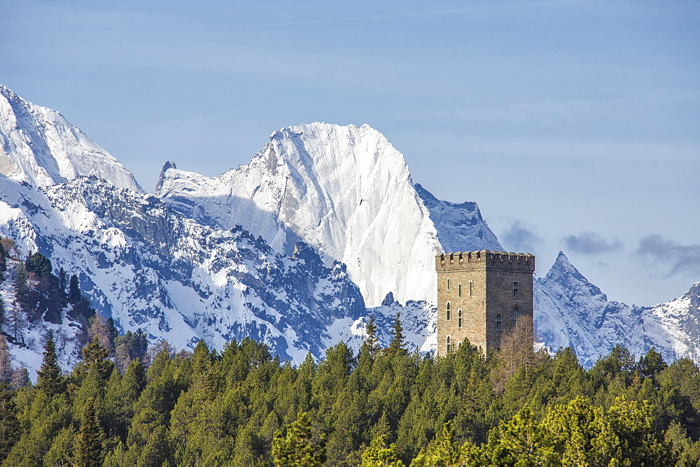 The Belvedere Tower frames the snowy peaks and Peak Badile on a spring day, Maloja Pass, Canton of Graubunden, Switzerland, Europe