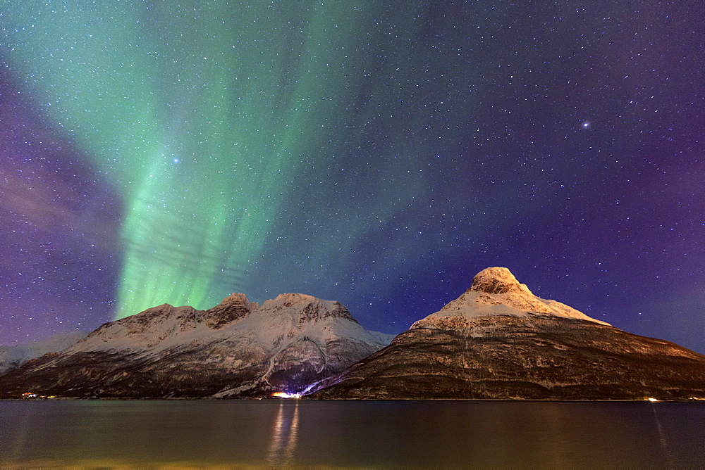 The Northern Lights illuminates the snowy peaks Oteren Storfjorden, Lyngen Alps, Troms, Lapland, Norway, Scandinavia, Europe