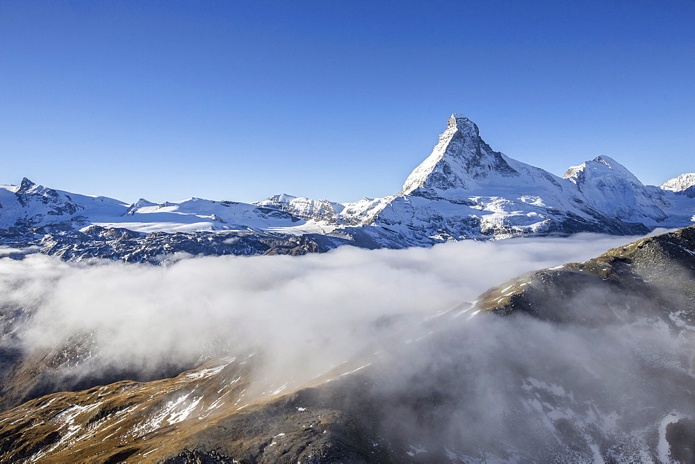 Fog revealing the mountain range surrounding the massif of the Matterhorn, Swiss Canton of Valais, Swiss Alps, Switzerland, Europe