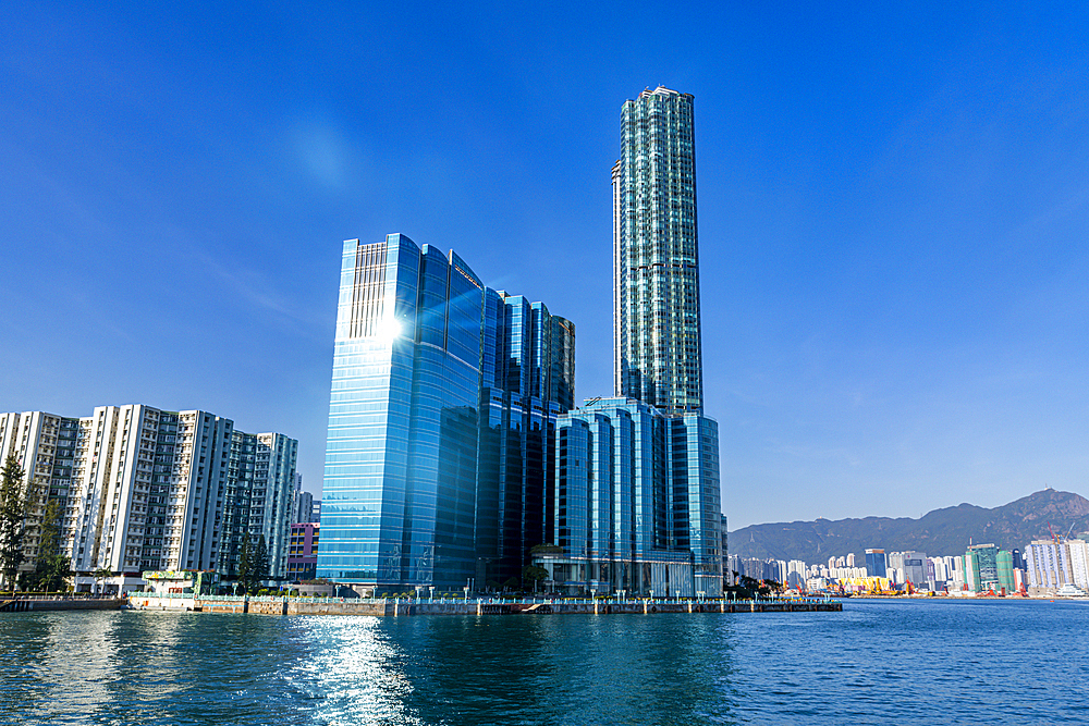 Highrise buildings in Victoria harbour at sunset, Hong Kong, China, Asia