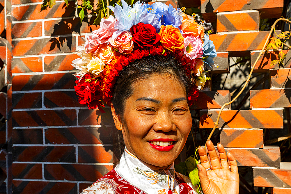 Traditionally dressed woman with a flower bouquet in her hair, Quanzhou, Fujian, China, Asia