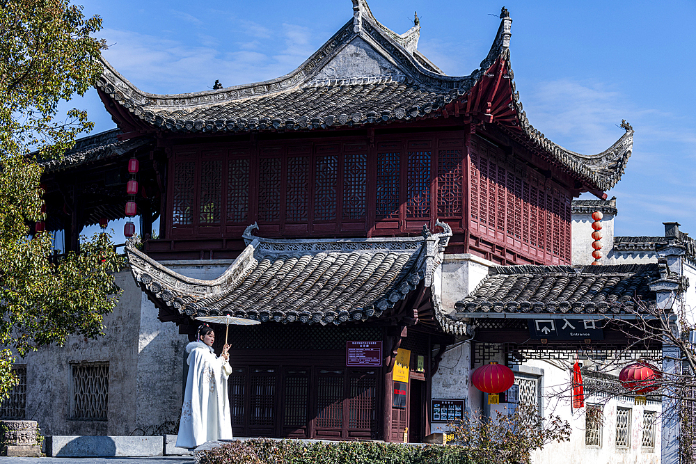 Woman posing in front of an old house, Xidi historical village, UNESCO World Heritage Site, Anhui, China, Asia