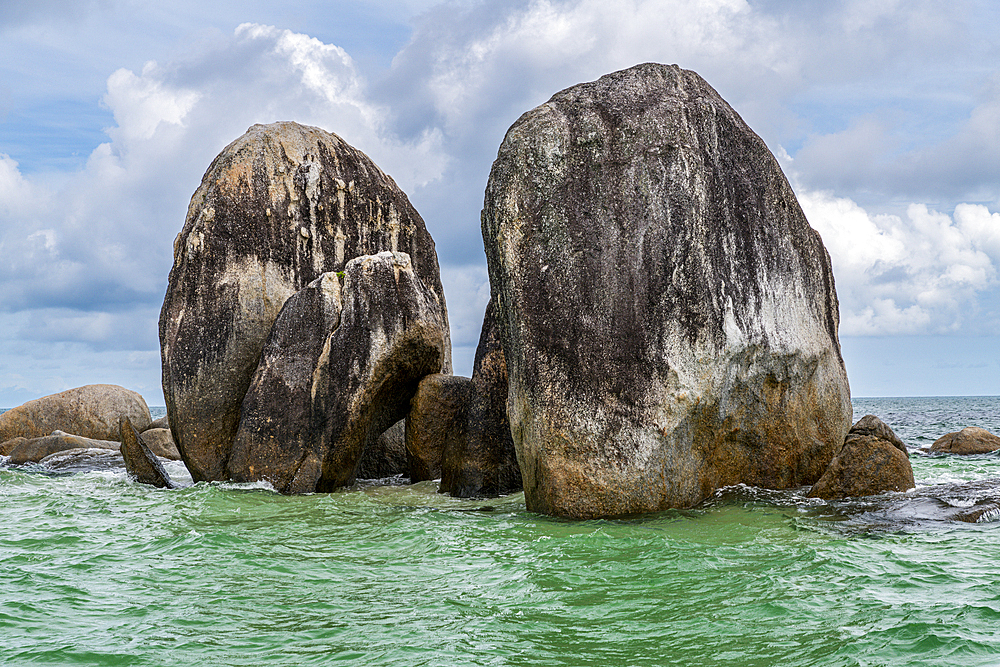 Granite rocks sticking out of the ocean, Belitung island off the coast of Sumatra, Indonesia, Southeast Asia, Asia