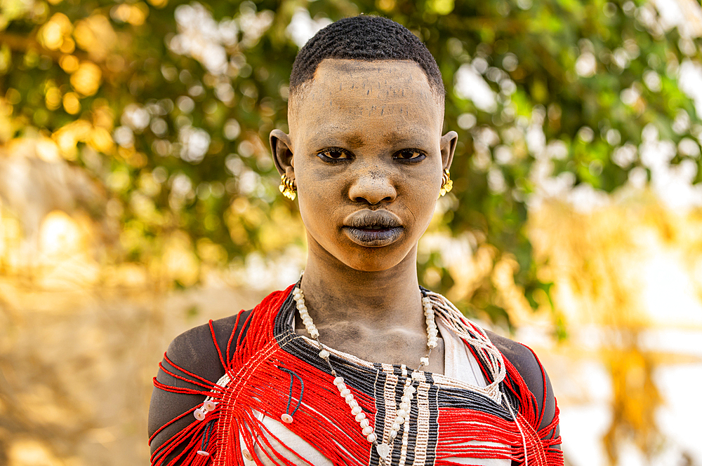 Mundari woman in a traditional dress with ash on face, Mundari tribe, South Sudan, Africa