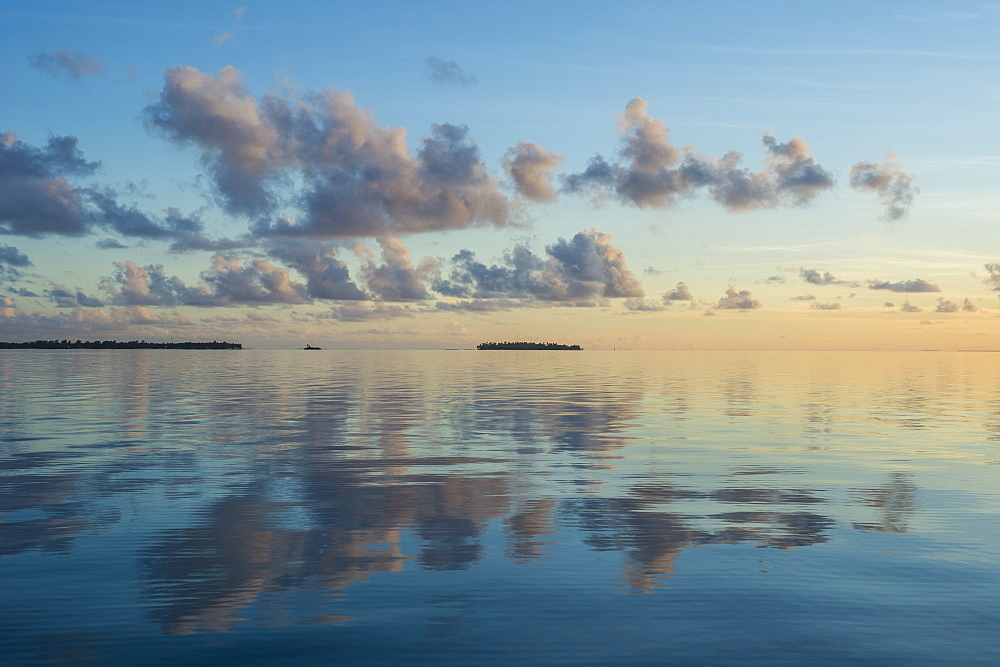 Sunset over the calm waters of Tikehau, Tuamotus, French Polynesia, Pacific