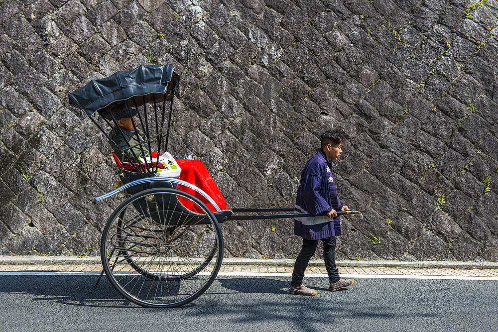 Japanese rickshaw in front of the Dogo Onsen old spa, Matsuyama, Shikoku, Japan, Asia