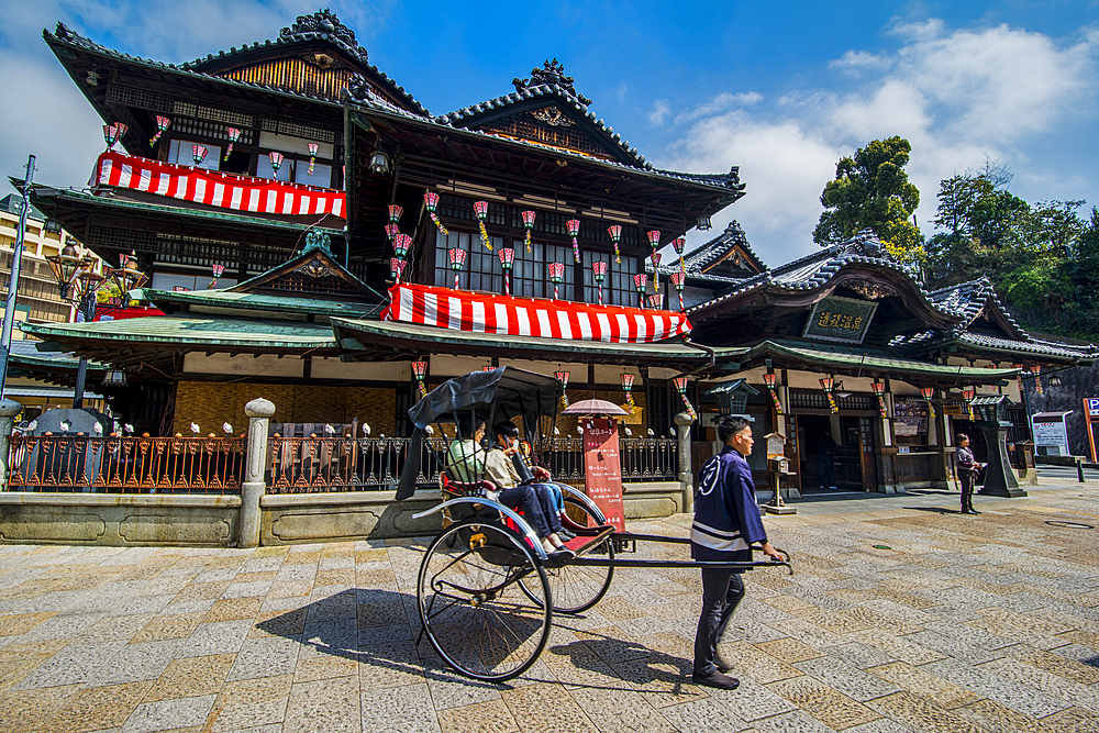 Japanese rickshaw in front of the Dogo Onsen old spa, Matsuyama, Shikoku, Japan, Asia