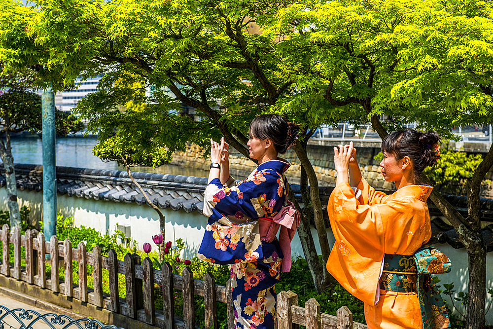 Traditionally dressed women in Dejima, a man made island in the port of Nagasaki, Kyushu, Japan, Asia