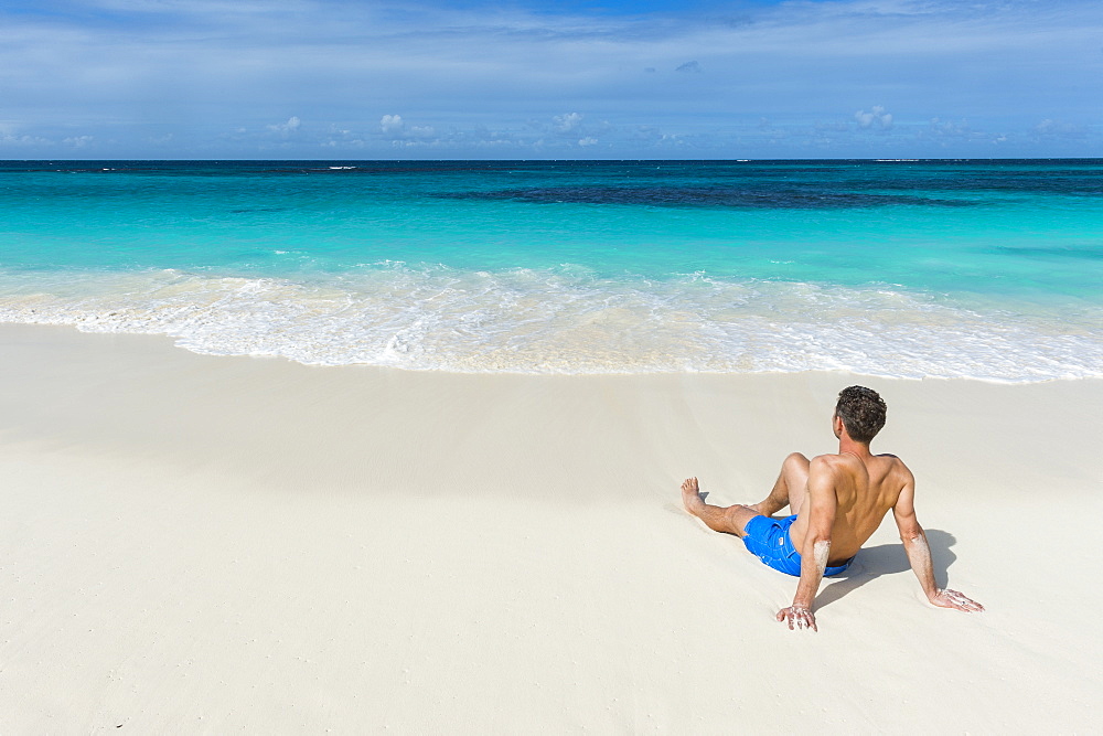 Man relaxing on the world class Shoal Bay East beach, Anguilla, British Oversea territory, West Indies, Caribbean, Central America