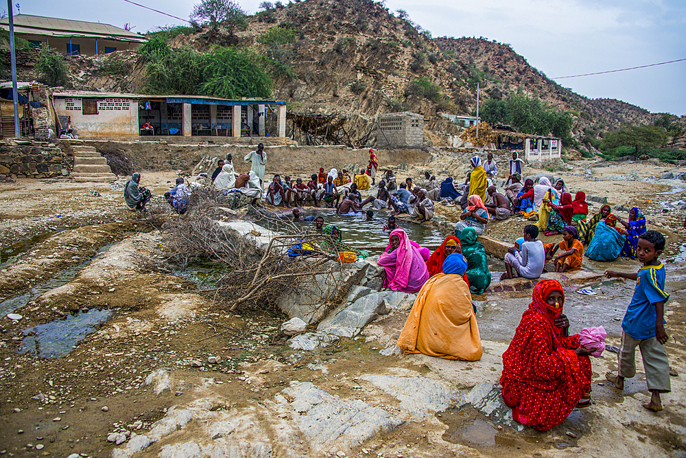 Men and women sitting in a hot spring in the lowlands of Eritrea, Africa