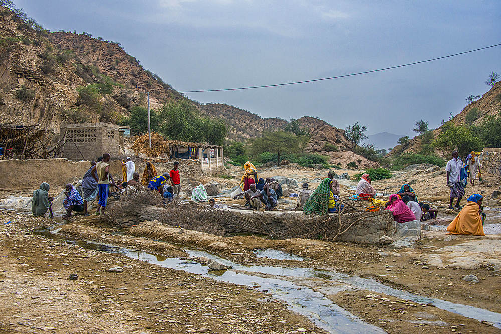 Men and women sitting in a hot spring in the lowlands of Eritrea, Africa