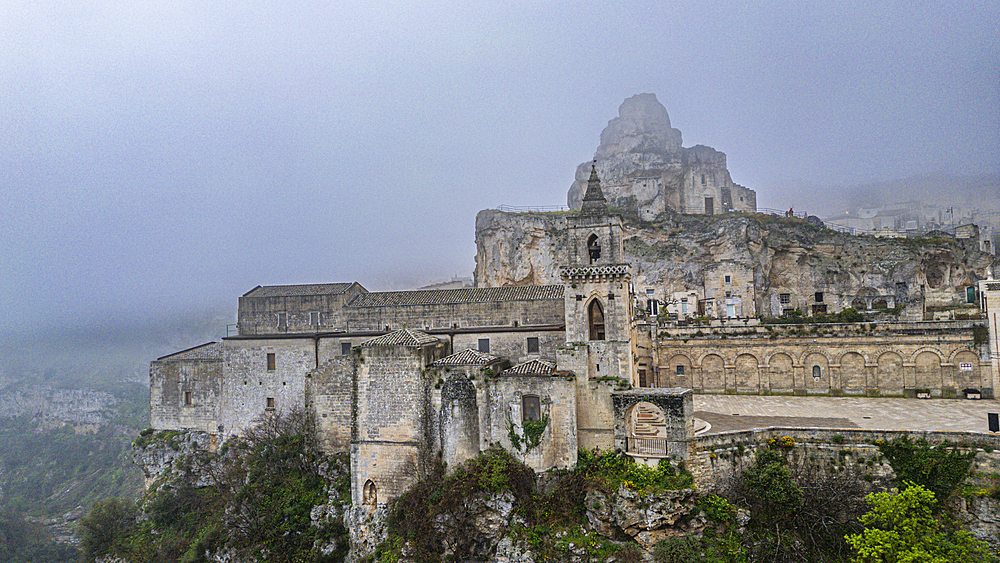 Aerial of the Sassi di Matera in fog, UNESCO World Heritage Site, Basilicata, Italy, Europe