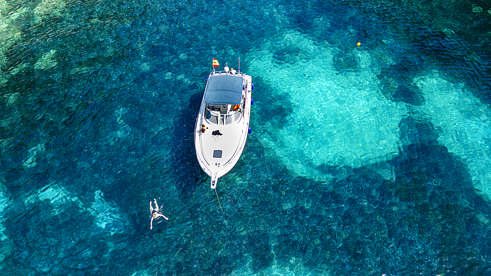 Aerial of a little motorboat in a bay on the Formentor Peninsula, Mallorca, Balearic islands, Spain, Mediterranean, Europe