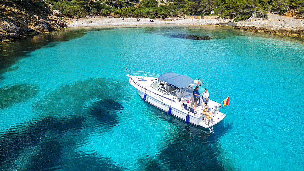 Aerial of a little motorboat in a bay on the Formentor Peninsula, Mallorca, Balearic islands, Spain, Mediterranean, Europe