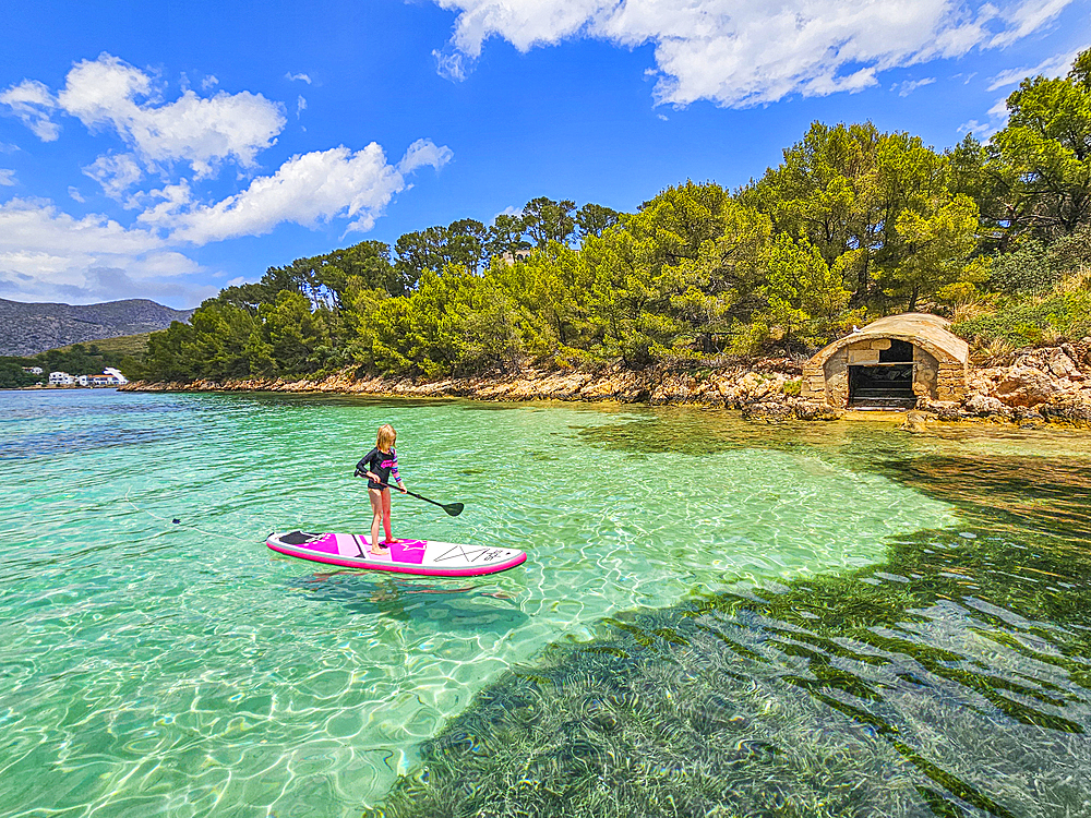 Girl on a SUP in the turquoise waters of the Formentor Peninsula, Mallorca, Balearic islands, Spain, Mediterranean, Europe