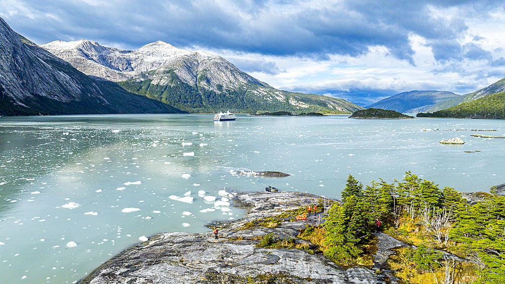 Aerial of a cruise ship anchoring below Pia glacier, Tierra del Fuego, Chile, South America